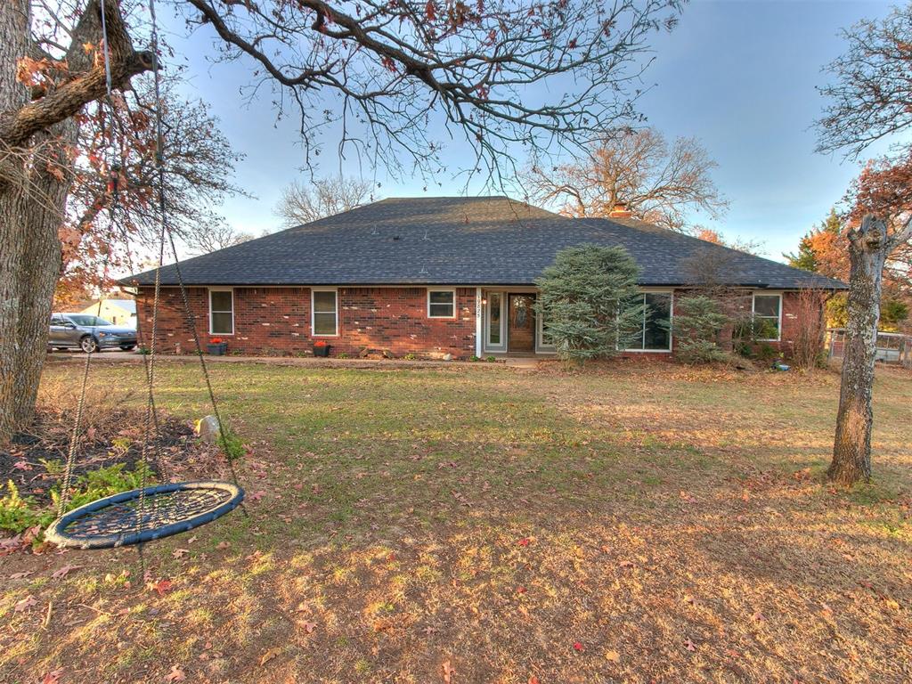 back of house with a lawn