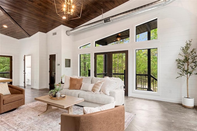 living room with concrete flooring, a chandelier, high vaulted ceiling, and wood ceiling