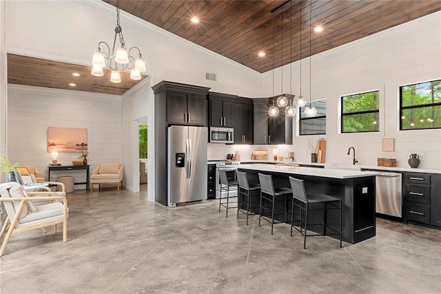 kitchen featuring a kitchen bar, appliances with stainless steel finishes, high vaulted ceiling, wooden ceiling, and a center island