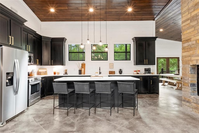 kitchen featuring a center island, stainless steel appliances, high vaulted ceiling, a breakfast bar area, and wood ceiling