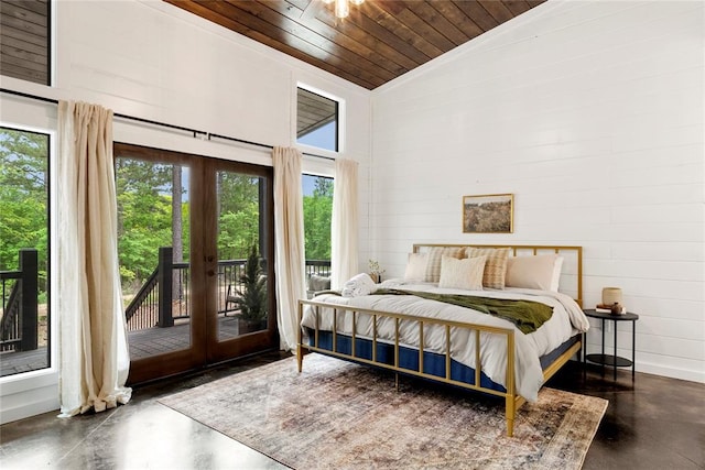 bedroom featuring access to outside, multiple windows, french doors, and wood ceiling