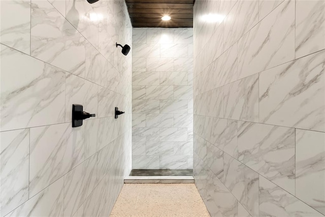 bathroom with a tile shower