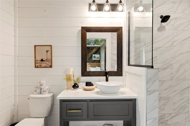 bathroom featuring a shower, vanity, and toilet