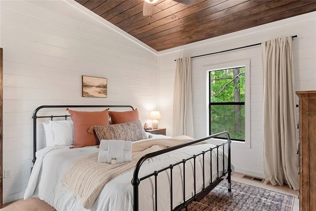 bedroom featuring hardwood / wood-style floors, ceiling fan, lofted ceiling, and wooden ceiling