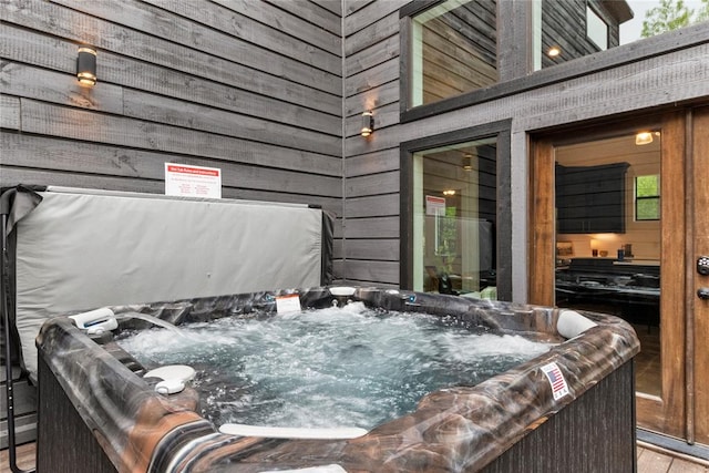 wooden terrace featuring a hot tub