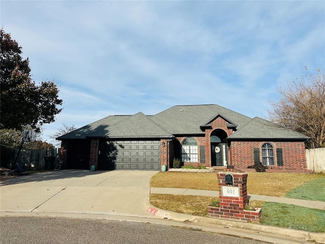 view of front facade featuring a garage and a front lawn