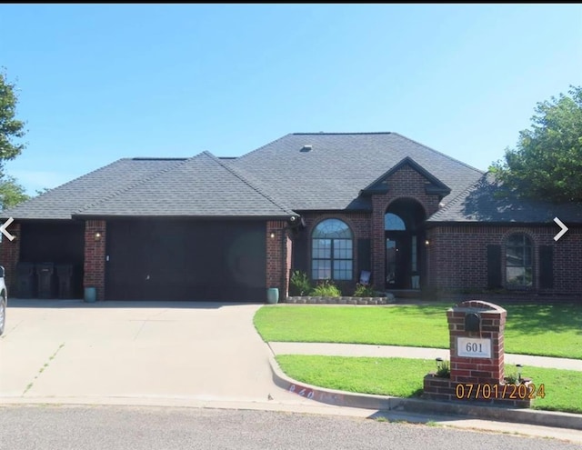 view of front facade with a garage and a front lawn