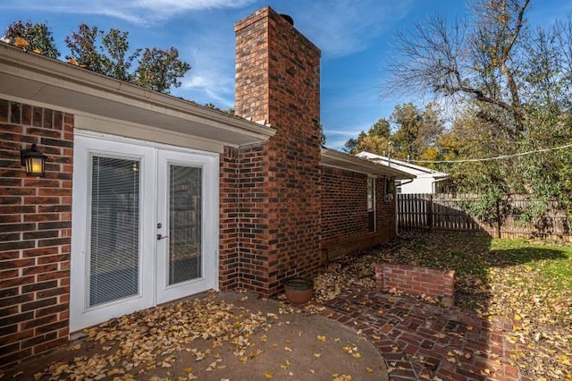 view of side of home featuring french doors and a patio area