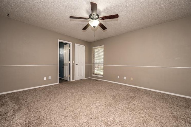 unfurnished bedroom featuring carpet flooring, a textured ceiling, and ceiling fan