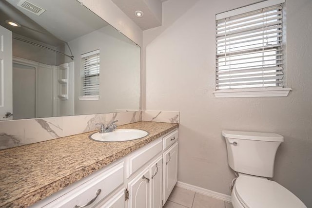 bathroom featuring tile patterned flooring, vanity, plenty of natural light, and walk in shower