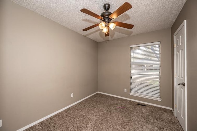 unfurnished room with carpet flooring, ceiling fan, and a textured ceiling