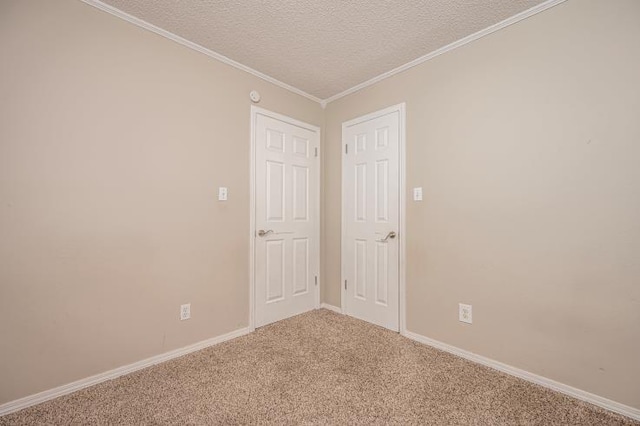 carpeted spare room featuring a textured ceiling and ornamental molding