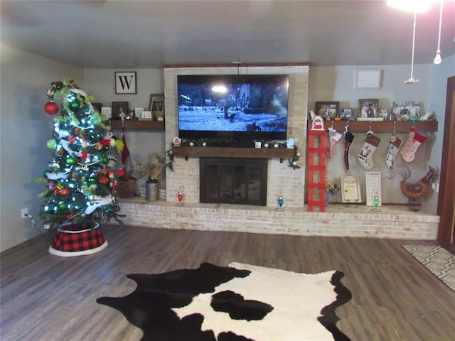 living room featuring wood-type flooring and a fireplace