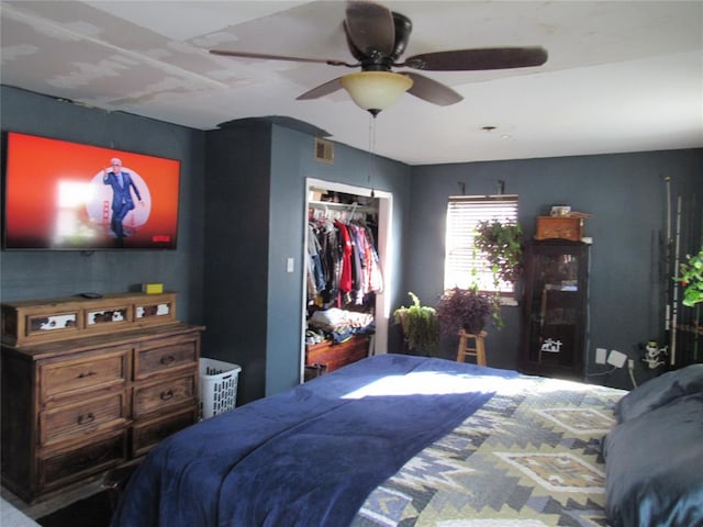 bedroom with ceiling fan and a closet