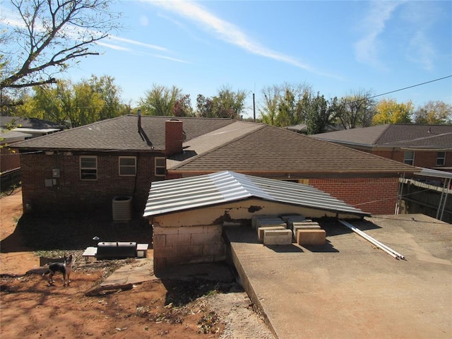 view of property exterior with cooling unit and a patio area