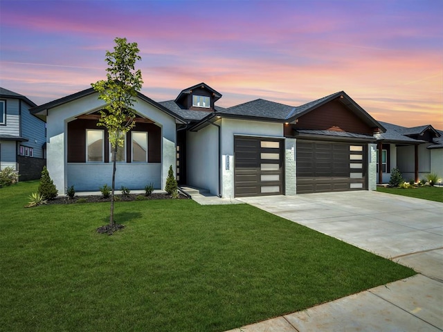 view of front of home featuring a garage and a yard