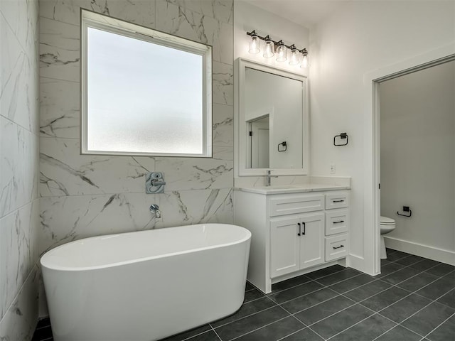 bathroom with vanity, a bath, tile patterned floors, and toilet