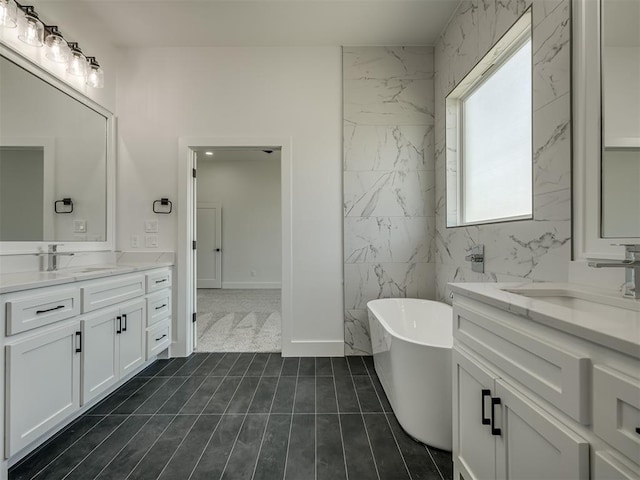 bathroom with vanity and a tub