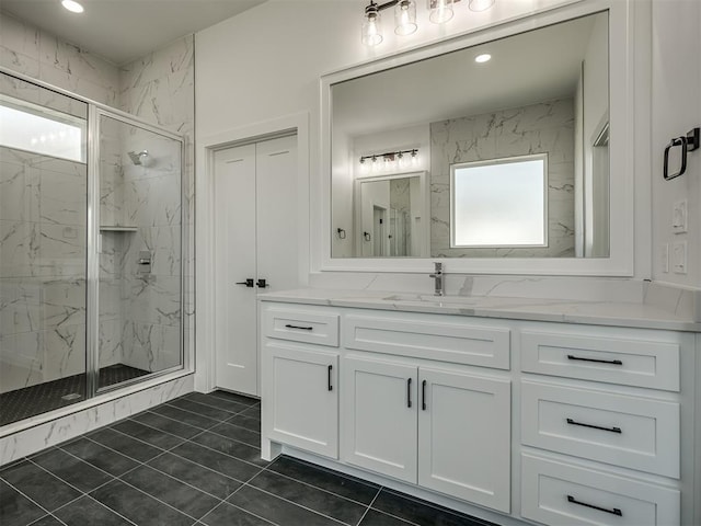 bathroom with walk in shower, vanity, and a wealth of natural light