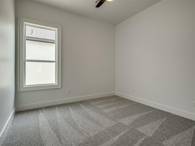 carpeted empty room featuring plenty of natural light and ceiling fan