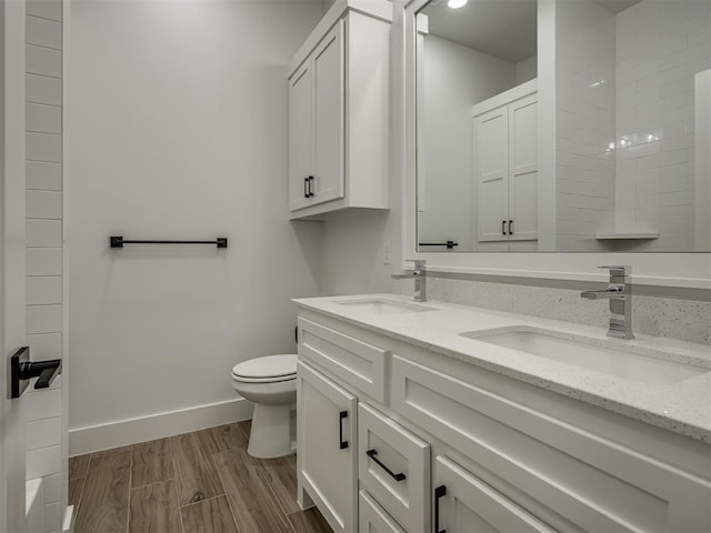 bathroom with vanity, wood-type flooring, and toilet