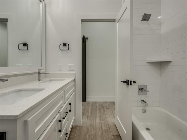 bathroom featuring vanity and tiled shower / bath