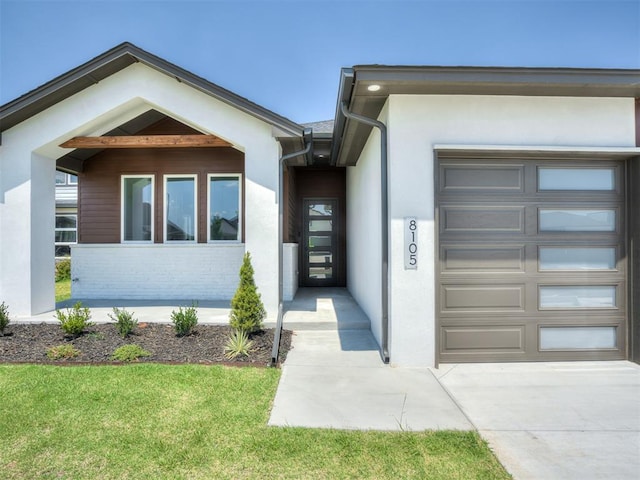 property entrance with a lawn