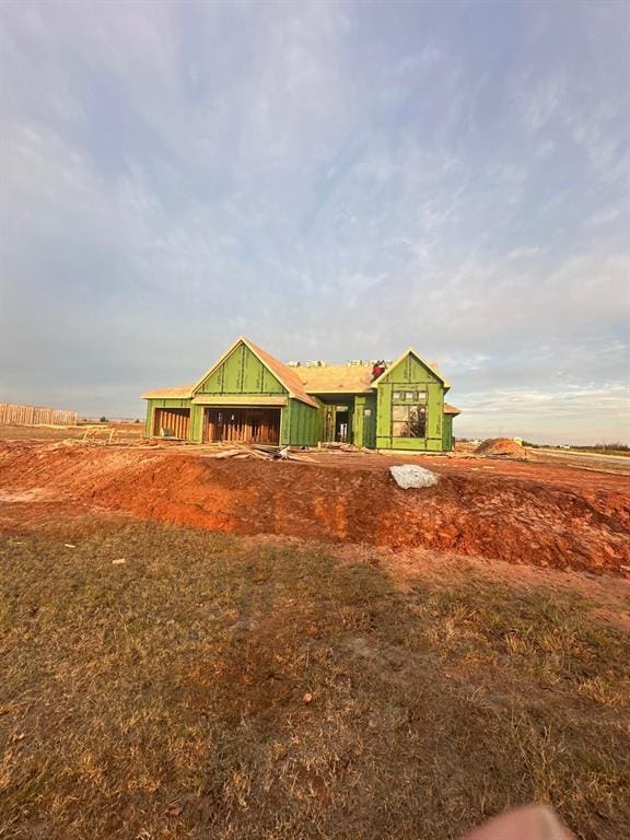 view of front of home with a rural view