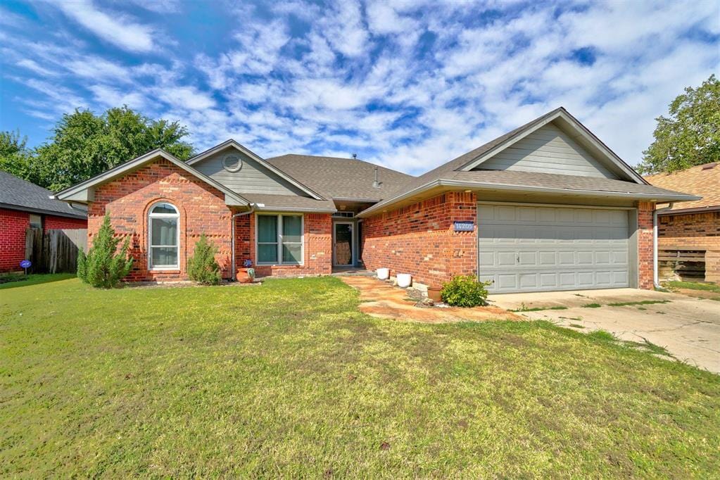 ranch-style home with a front lawn and a garage