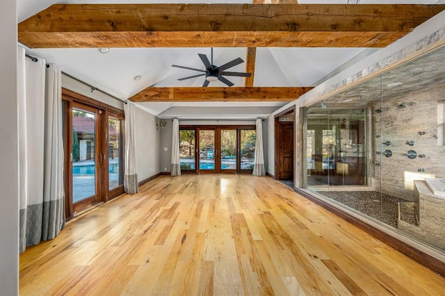 interior space with ceiling fan, lofted ceiling with beams, french doors, and light wood-type flooring