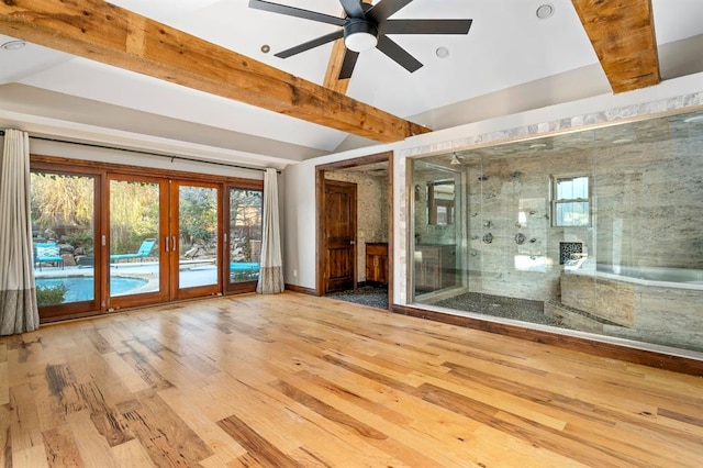 unfurnished room featuring ceiling fan, lofted ceiling with beams, french doors, and light wood-type flooring