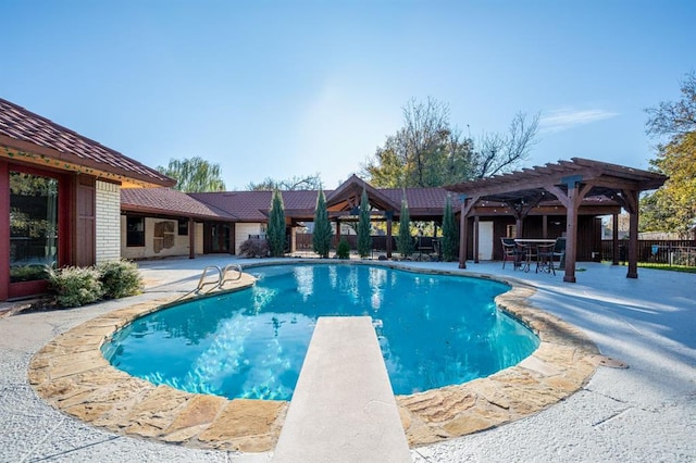 view of pool featuring a diving board, a patio, and a pergola