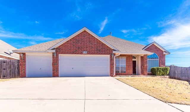 ranch-style house with a garage, brick siding, and fence