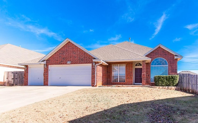 ranch-style house with brick siding, roof with shingles, concrete driveway, fence, and a garage