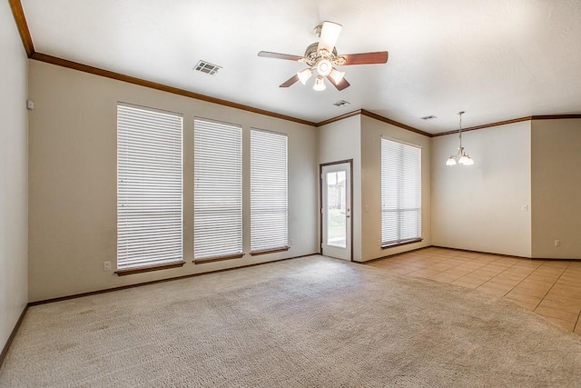 tiled spare room with ceiling fan with notable chandelier and crown molding