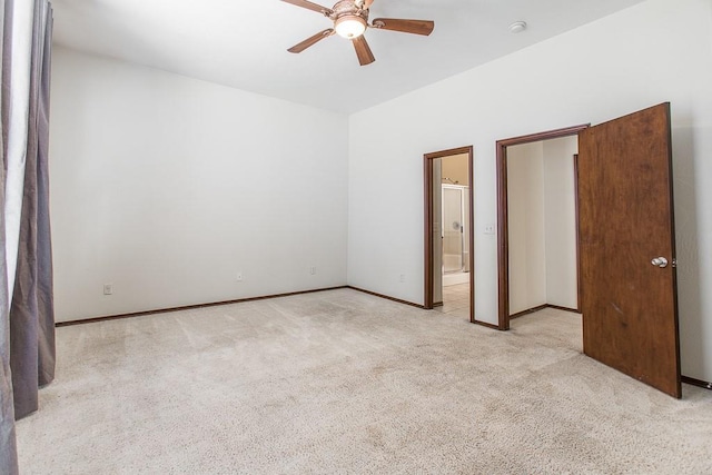 unfurnished bedroom featuring ensuite bathroom, ceiling fan, and light carpet