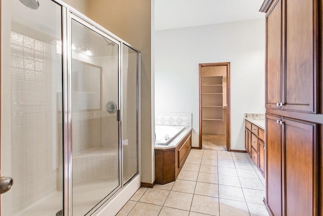 bathroom with tile patterned flooring, vanity, and independent shower and bath