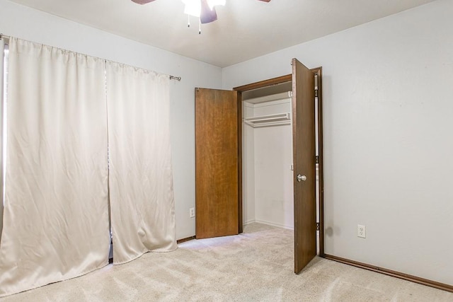 unfurnished bedroom featuring ceiling fan, a closet, and light colored carpet