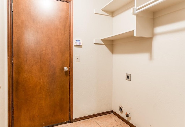 washroom featuring electric dryer hookup and light tile patterned floors