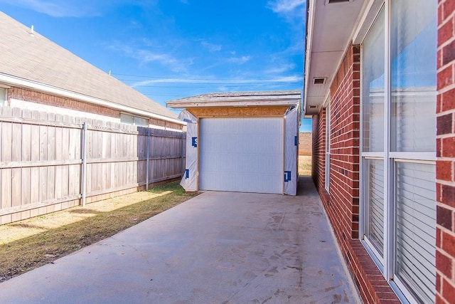 view of patio / terrace with an outdoor structure and a garage