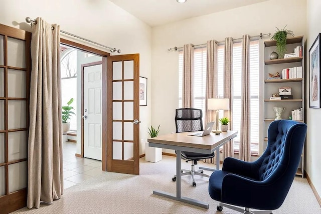 office area featuring light carpet, light tile patterned flooring, and baseboards