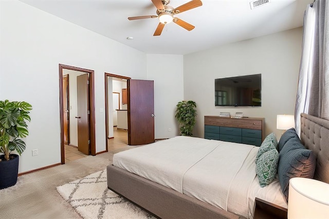 bedroom featuring baseboards, visible vents, a ceiling fan, and light colored carpet