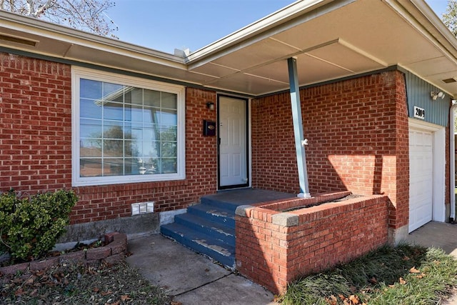 doorway to property with a garage