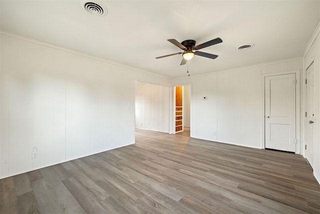 907 S Wilson Ave, El Reno, OK 73036 - unfurnished room with hardwood / wood-style flooring, ceiling fan, and ornamental molding