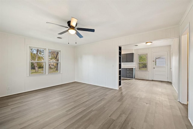 907 S Wilson Ave, El Reno, OK 73036 - unfurnished living room featuring light hardwood / wood-style flooring, plenty of natural light, and ceiling fan