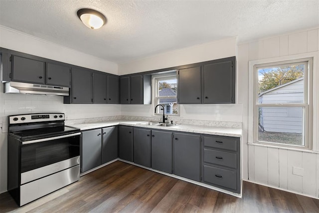 907 S Wilson Ave, El Reno, OK 73036 - kitchen featuring stainless steel range with electric cooktop, dark wood-type flooring, sink, a textured ceiling, and tasteful backsplash