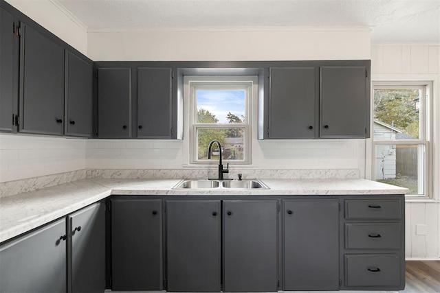 907 S Wilson Ave, El Reno, OK 73036 - kitchen featuring decorative backsplash, sink, dark wood-type flooring, and a textured ceiling