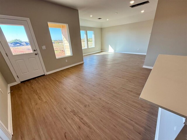 unfurnished living room with wood-type flooring