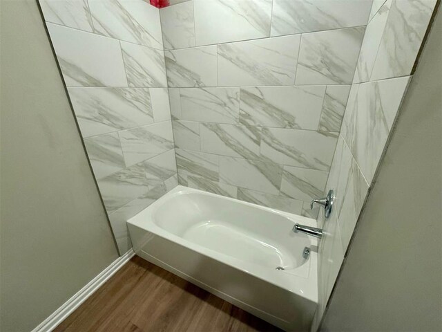 bathroom with wood-type flooring and tiled shower / bath combo