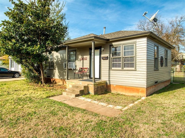 bungalow-style home with covered porch and a front yard